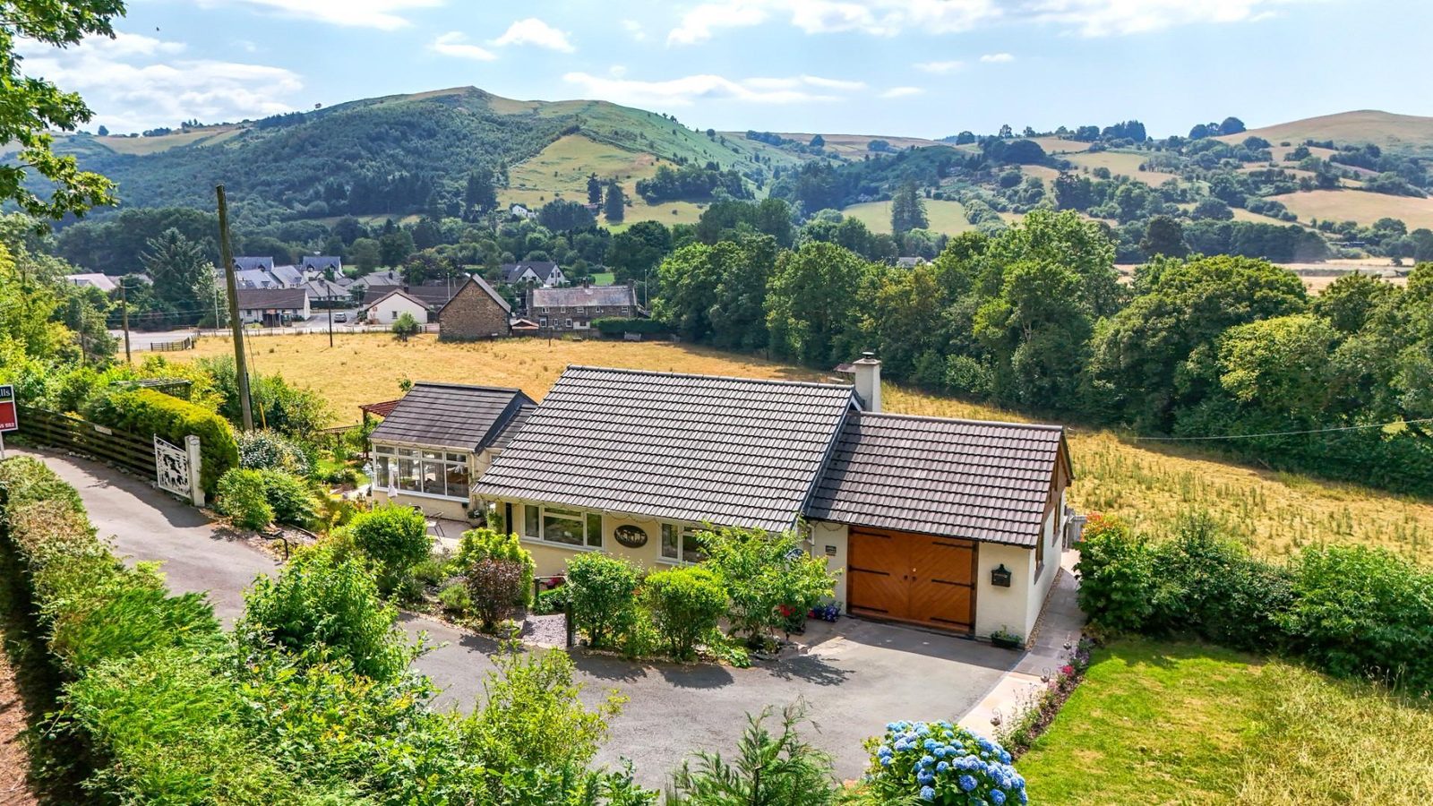 Welshpool: bungalow with outbuildings