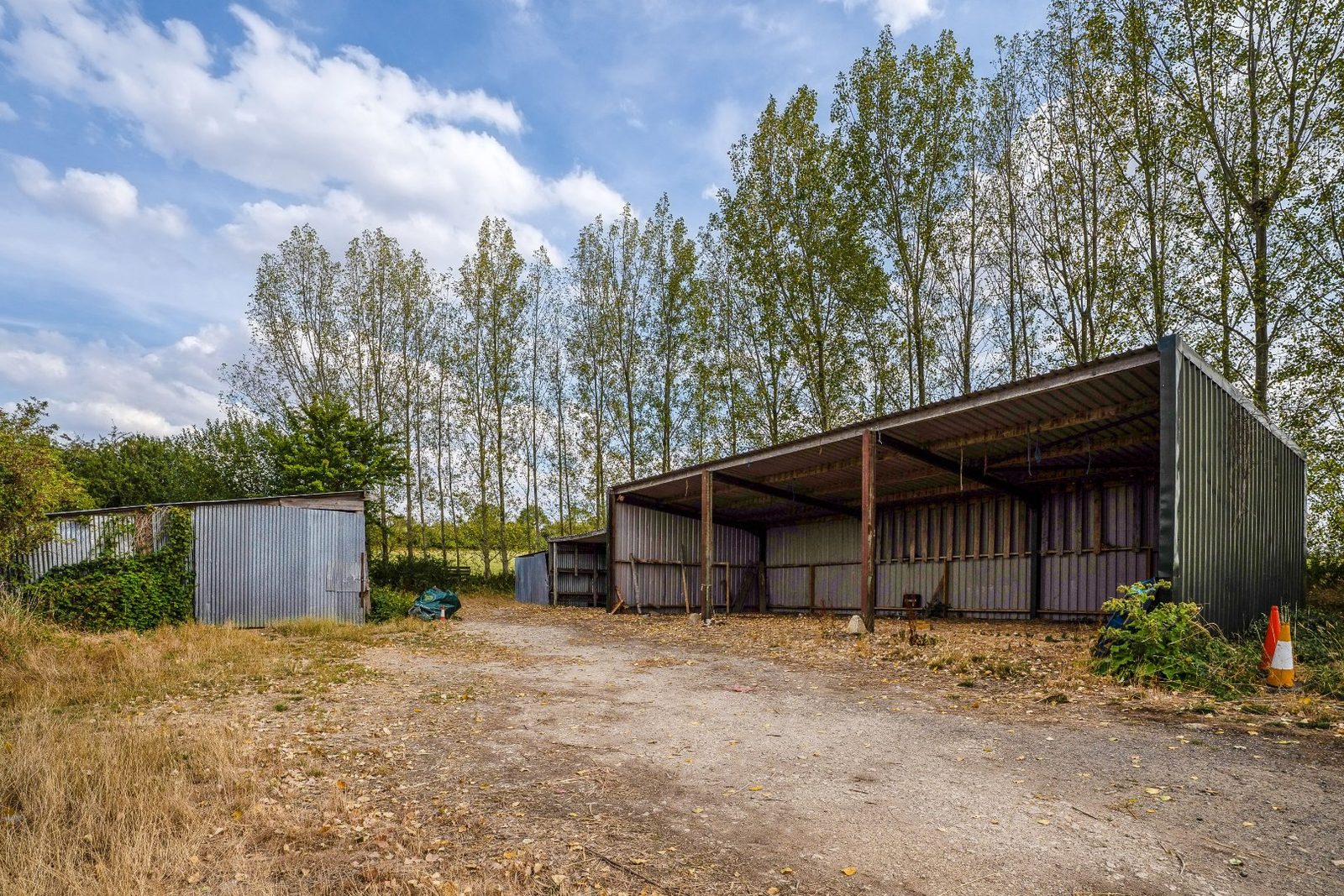 8.26 acres of land together with a range of agricultural buildings on the A429